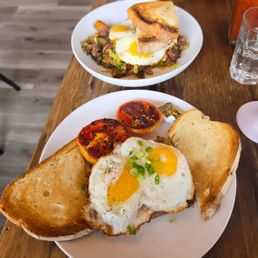 Corn beef hash (front) and steak/brussel sprouts (back) each w/ 2 sunny side eggs and toast Corn beef hash (front) and steak/brussel sprouts (back) each w/ 2 sunny side eggs and toast