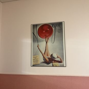 Skooters Restaurant - A magazine cover on a plain wall shows a woman lying down with her legs raised, holding a large red balloon. The cover includes text and a barcode. - Burgers Near Me - Windsor Locks, Connecticut