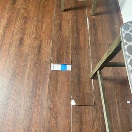 a wooden floor with a blue sticker on it