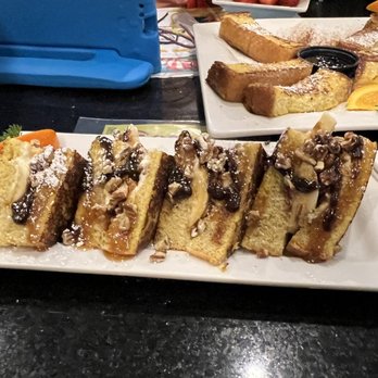 Keke's Breakfast Cafe - Banana nut caramel stuffed French toast with chocolate drizzle - Breakfast & Brunch Near Me - Windermere, Florida Keke's Breakfast Cafe - Banana nut caramel stuffed French toast with chocolate drizzle - Breakfast & Brunch Near Me - Windermere, Florida