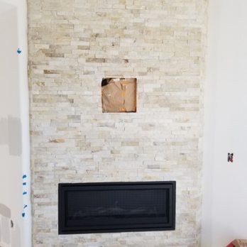 Mitchell Tile And Stone - a fireplace in a living room - Flooring Near Me - San Clemente, California Mitchell Tile And Stone - a fireplace in a living room - Flooring Near Me - San Clemente, California