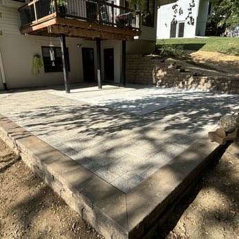 Smarter Scapes - Paver patio/concrete with uplifting retaining wall. - Landscaping Near Me - Omaha, Nebraska Smarter Scapes - Paver patio/concrete with uplifting retaining wall. - Landscaping Near Me - Omaha, Nebraska