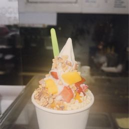 Plain frozen yogurt topped with fruits, nuts & white chocolate bites Plain frozen yogurt topped with fruits, nuts & white chocolate bites