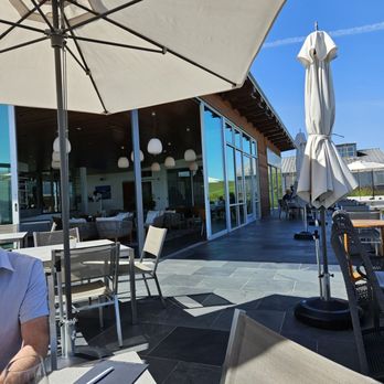 Cuvaison - Comfortable seating outdoors looking into the building - Wineries Near Me - Napa, California