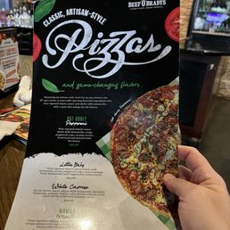 hand holding a pizza