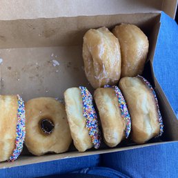 a box of donuts with sprinkles