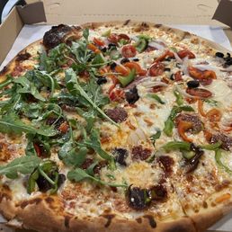 Large pizza with half Ottoman (left) and half Meat n' Veggie Conbo (right)