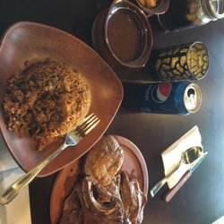 Fried pork chops, seasoned rice and red beans.