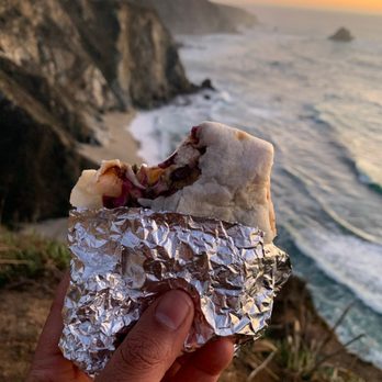Aki Fresh Mex - a hand holding a piece of food - Mexican Near Me - Marina, California Aki Fresh Mex - a hand holding a piece of food - Mexican Near Me - Marina, California