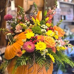 Three Forks Floral - Fall pumpkin arrangement fill with beautiful warm fall blooms.