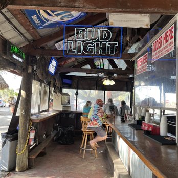 Tiki Bar - a man sitting at the bar - Tiki Bars Near Me - Fort Myers, Florida Tiki Bar - a man sitting at the bar - Tiki Bars Near Me - Fort Myers, Florida