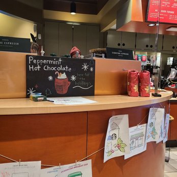 Starbucks - a sign on the counter of a coffee shop - Coffee & Tea Near Me - Millwood, Washington Starbucks - a sign on the counter of a coffee shop - Coffee & Tea Near Me - Millwood, Washington