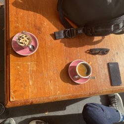 Smiths Alternative Bookshop - Outdoor seating at Smith's with glass of iced tall black and mug of hot tall black coffee.