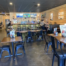 Large space with a bar, booths , and tables Large space with a bar, booths , and tables