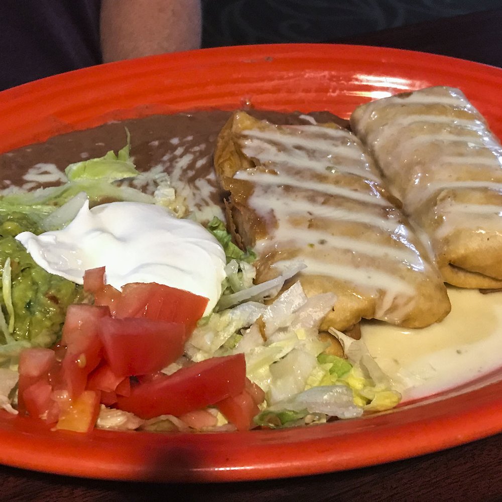 Poblanos Mexican Grill & Bar - Dos Chimichangas ($10) were nicely fried, covered in runny cheese and stuffed with flavorful shredded chicken. - Mexican Near Me - Winamac, Indiana Poblanos Mexican Grill & Bar - Dos Chimichangas ($10) were nicely fried, covered in runny cheese and stuffed with flavorful shredded chicken. - Mexican Near Me - Winamac, Indiana