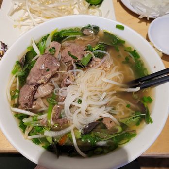 Pho Papa - Pho #13: beef flanks and tendons. Plate of white onions in top right hand corner. - Vietnamese Near Me - San Jose, California Pho Papa - Pho #13: beef flanks and tendons. Plate of white onions in top right hand corner. - Vietnamese Near Me - San Jose, California