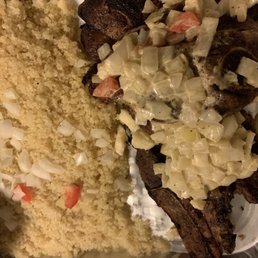 a plate of food with meat and rice a plate of food with meat and rice