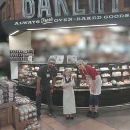 ows two people standing in front of a bakery