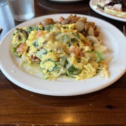 Scramble with spinach, onions, bacon and tomato. Also comes with a side of potatoes. Scramble with spinach, onions, bacon and tomato. Also comes with a side of potatoes.