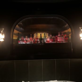 Mr. Lyons - Cool bottle display behind fluted mcm glass - Steakhouses Near Me - Palm Springs, California Mr. Lyons - Cool bottle display behind fluted mcm glass - Steakhouses Near Me - Palm Springs, California