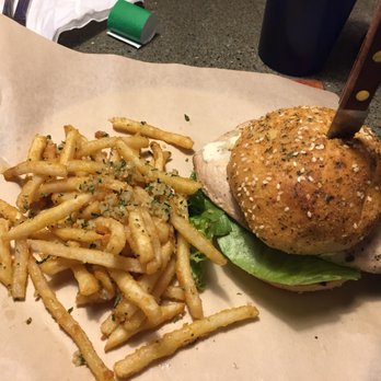 Rickety Cricket Brewing - The Yard Bird sandwich looks like a burger. The bun is a homemade pretzel bun. The chicken breast was so tender and flavorful. Garlic fries. - Pizza Near Me - Kingman, Arizona