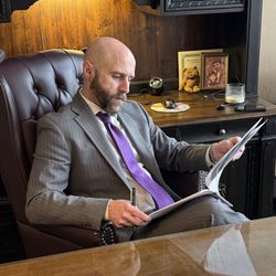 The Urbanic Law Firm - Attorney Corey Brennan reviewing a case.