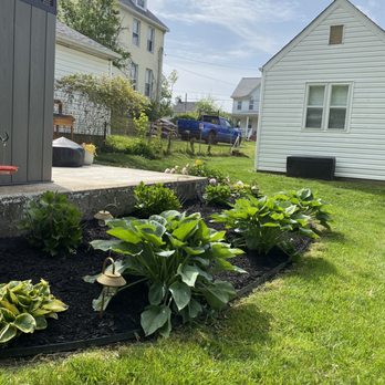 J Lawn Care - a garden in the foreground - Lawn Services Near Me