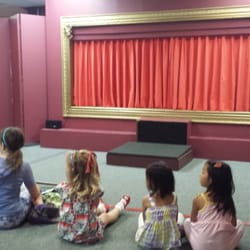 Paper Moon Puppet Theatre - Kids sitting on the floor waiting for the show to start.