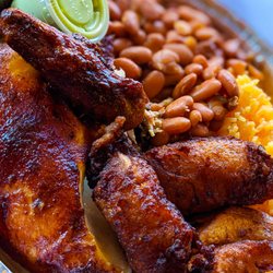 Golden Chicken - Half chicken, golden rice & beans and sweet plantains. Side of green sauce