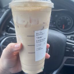 Pumpkin spice chai latte - iced in an upsized cup to fit the extra cold foam and not spill out .