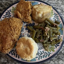 Fried chicken with mashed potatoes and green beans and a roll.