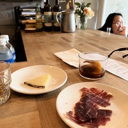 a woman sitting at a table with a plate of food a woman sitting at a table with a plate of food