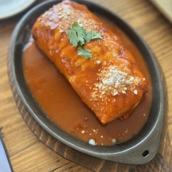 Panxa Cocina - smothered breakfast burrito: scramble eggs, potatoes, queso oaxaca, pork sausage smothered in chimayo red = $21 - Cocktail Bars Near Me - Long Beach, California