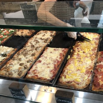 ZeroZero39 Pizzeria - Cutting up slices for final heating up - Pizza Near Me - Huntington Beach, California ZeroZero39 Pizzeria - Cutting up slices for final heating up - Pizza Near Me - Huntington Beach, California