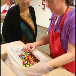 Gingerbread Traditions - GTI staff sorting candy.