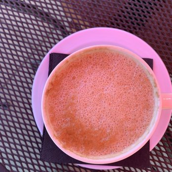 Rail Side Cafe - Cappuccino with soy. Pink glow from the red outdoor umbrellas. - Coffee & Tea Near Me - San Dimas, California Rail Side Cafe - Cappuccino with soy. Pink glow from the red outdoor umbrellas. - Coffee & Tea Near Me - San Dimas, California