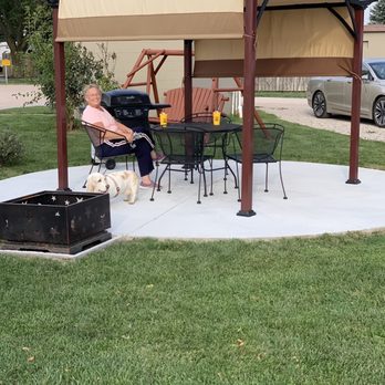 Grand Island KOA - Dinner and drinks on the brand new patio! Check out the paved sidewalk for the RV - Campgrounds Near Me - Doniphan, Nebraska