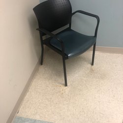MedPost Urgent Care of Rowlett - Dingy room with rusty floors.