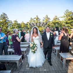 Photo of a wedding ceremony taking place at the pergola on the Mystic Creek grounds.