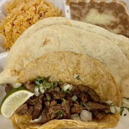 Carne asada crispy taco, chicken taco (hiding behind crispy taco), beans with cheese and rice