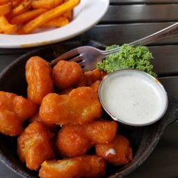 a bowl of chicken nuggies and a plate of fries a bowl of chicken nuggies and a plate of fries