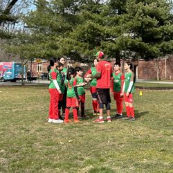 Soccer Cric - Kids getting instructions from their coach