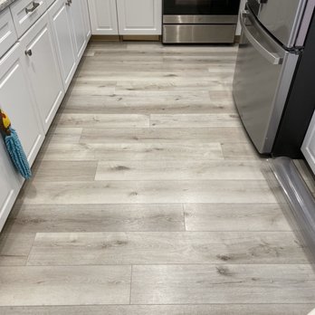 Orion Flooring - a kitchen with white cabinets and stainless steel appliances - Flooring Near Me - Rialto, California Orion Flooring - a kitchen with white cabinets and stainless steel appliances - Flooring Near Me - Rialto, California