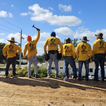 Global Contractors - a group of workers standing on a roof - Roofing Near Me - North Miami, Florida
