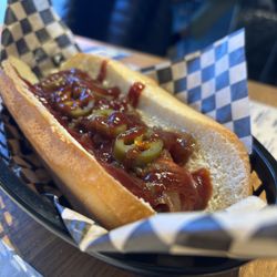 Seattle DAWG HOUSE - The "Seattle Dog" comes with cream cheese, caramelized onions, bbq sauce, and jalapenos on top!