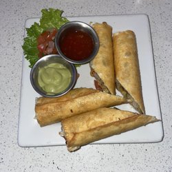 Seafood flautas with sweet signature sauce and spicy signature sauce on the side.