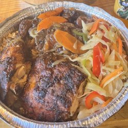 Jerk chicken and oxtail with rice and peas and coleslaw. Yummmmmm!!!