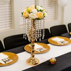 KCH Event Equipment Rental - Black chair cover, black table cloth, ivory chiffon, rose gold flower centerpiece