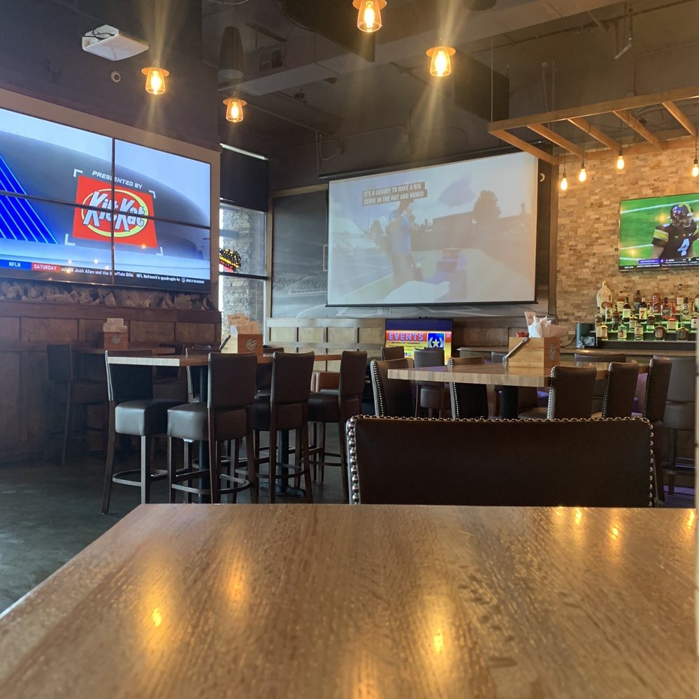 a bar with a large screen in the background a bar with a large screen in the background