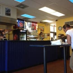 a man standing at a counter in a restaurant a man standing at a counter in a restaurant